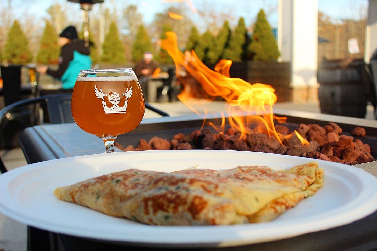 Enjoying a crepe and a local beer by the fire pit